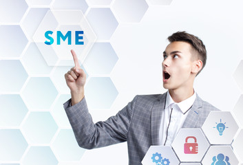 The concept of business, technology, the Internet and the network. A young entrepreneur working on a virtual screen of the future and sees the inscription: SME