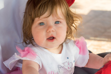 Portrait of cute baby in carriage on resort