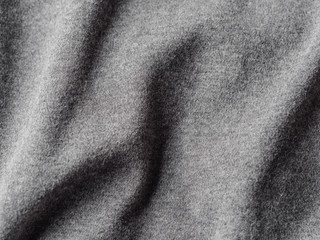 Gray cotton fabric texture. Clothes cotton jersey background with folds