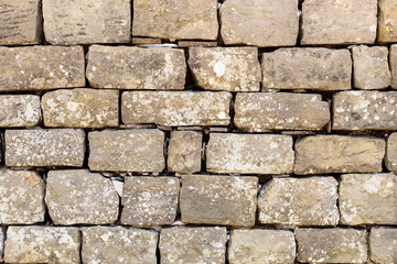 The background old brown stony wall