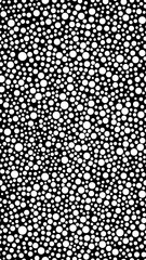 Modern animalistic background with white circles on a black sheet. Trendy geometric background in Dalmatian color 1080 x 1920 pixels for interior, design, walls. Vertical seamless pattern option.
