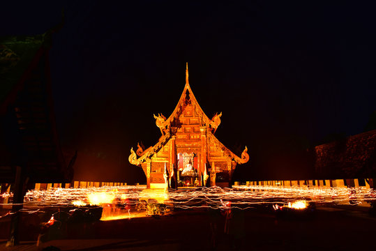 People carry the candle and walking around pagada