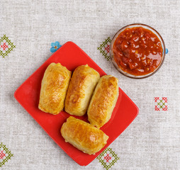 Pastries and sauce on a plate on a napkin.