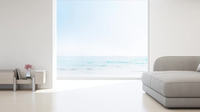 Sea view living room of luxury summer beach house with glass window and wooden floor. Empty white concrete wall background in vacation home or holiday villa. Hotel interior 3d illustration.