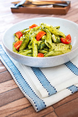 Pasta with pesto sauce and nuts on a the table