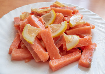 Slices of salted salmon with lemon. Slices of salted salmon with lemon for sushi rolls