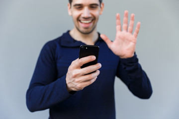 Cheerful young man having a video call