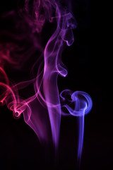 Abstract backgrounds and wallpapers. Colorful smoke on black background.