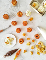 The process of cooking and decorating cupcakes top view.