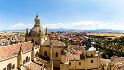 Segovia, Spain – Panoramic 16:9 view of the dome of the Cathedral and of Segovia old town from the top of the bell tower during Summer time. The peaks of Sierra de Guadarrama are visible behind