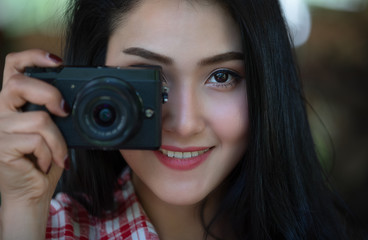 young asian women girl shooting with a digital camera