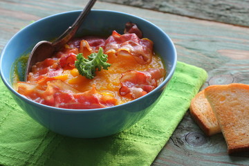Creamy pumpkin soup served with crispy bacon