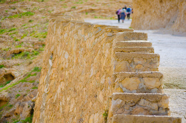 Group of people finished climbing limestone stairway on mountain slope .Steps to success concept