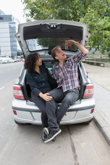 Ethnic couple with a car in the city