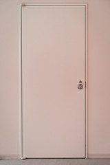 Pink door with frame on pink wall background.