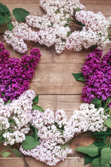 Flat lay top view photo of spring lilac flowers. lilac flowers bouquet on brown background. top view with copy space