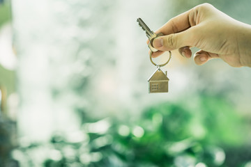 House model and key in home insurance broker agent &lsquo;s hand or in salesman person. Real estate agent offer house, property insurance and security, affordable housing concepts