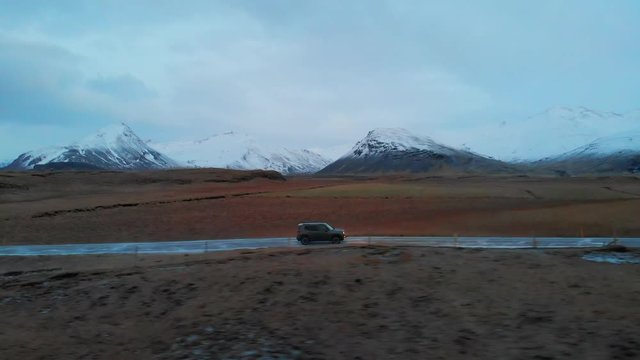 Following a Car with Mountains side