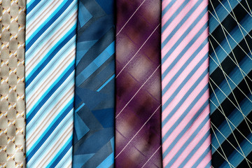 A lot of multi-colored neckties. Background from ties. Sale.