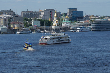 View of Dnieper river and pleasure boats floating on water. 