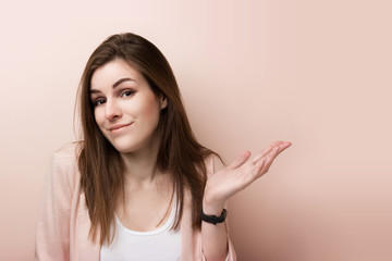 Young pretty business woman standing isolated on pink background