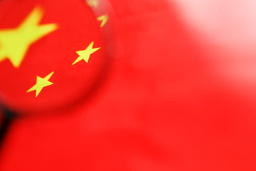 The People's Republic of China a flag is watched through magnifying glass. Spies and observation of People's Republic of China. Monitoring of a condition of China