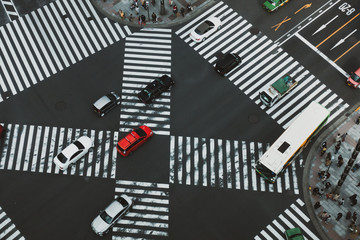 Overhead view of taxis and other vehicles passing through the landmark Ginza Sukiyabashi crossing. 