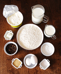 Ingredients for coffee cream cake on dark wooden background. Top veiw