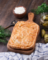 Homemade puff pie with pickled cucmbers and cottage cheese