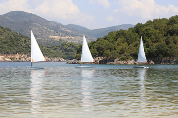 Small sail boats at Bella Vraka beach. Syvota, Greece.