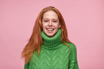 Trendy laughing woman in green sweater 