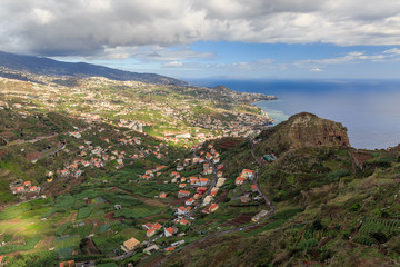 Fototapeta na wymiar Beautiful panorama landscape of the steep coastline of Madeira on a cloudy summer day