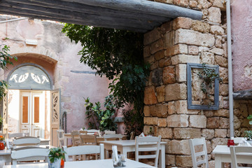 Traditional restaurant inside an alley at the old city of Chania. Crete island, Greece.