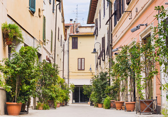 Fototapeta na wymiar Beautiful street with flowers in the Grosetto town, Tuscany, Italy, Popular touristic destination in Europe