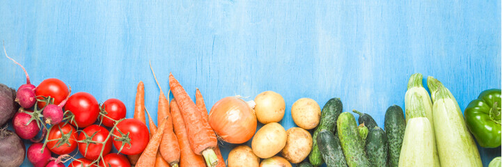 Fresh organic farm vegetables, Health care, on a blue wooden background. Harvest. Country style. Concept of a farm fair. banner. Flat lay, top view
