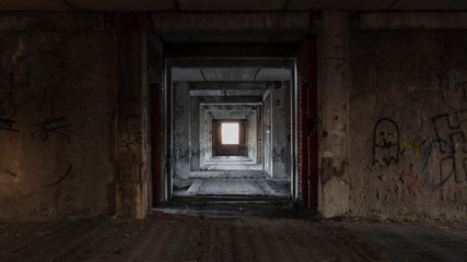 View of the rooms of an unfinished abandoned house with a window lit by the bright sun