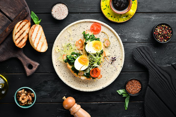 Sandwich with spinach, egg and tomatoes. croissant. Breakfast. In the plate. Top view. Flat lay composition Free copy space.