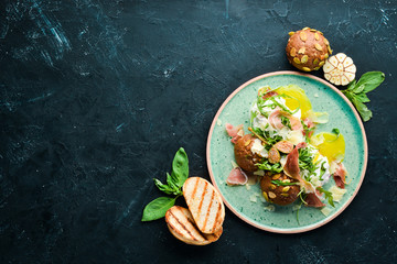 Sandwich with proshutto, egg and arugula. Breakfast. In the plate. Top view. Flat lay composition Free copy space.