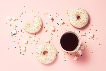 Cup of coffee, Fresh tasty sweet donuts on a pink background. Fast food concept, bakery, breakfast, sweets, coffee shop. Flat lay, top view, copy space.