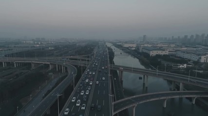 Aerial top view of highway interchange on the sunset. Aerial top view of road junction from above, automobile traffic and jam of many cars, useful for engineering, industrial, transportation concept