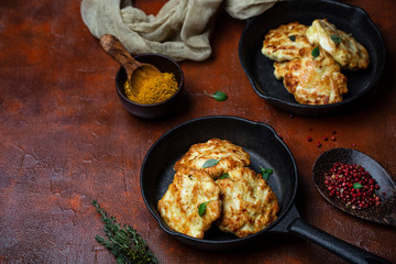 chicken cutlets with cheese on a cast iron pan