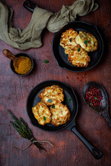 chicken cutlets with cheese on a cast iron pan