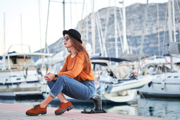 Young stylish girl in a sea port