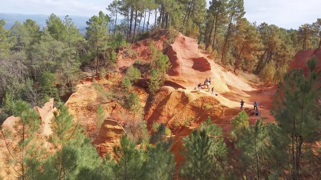 The Trail of Ochres in 4k. Tourists enchanted by the red color of the Le Sentier des Ocres. An old open pit next to the tourist town of Roussillon