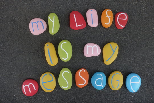 My life is my message, words of wisdom with colored stones over black volcanic sand