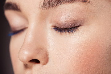cropped view of woman with trendy make up posing with eyes closed