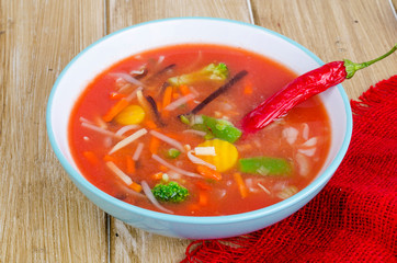 Spicy tomato soup with red peppers and vegetables.