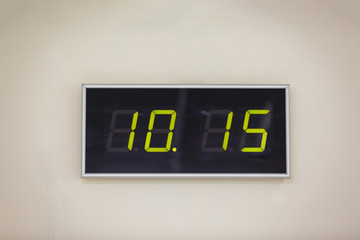 Black digital clock on a white background showing time 10.15 minutes
