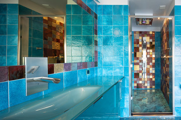 Blue bathroom with shower and big mirror