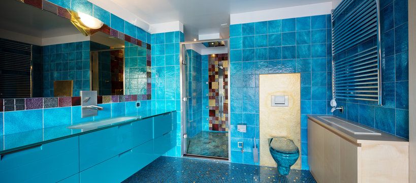 Blue bathroom with shower and big mirror